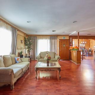 A spacious living room with elegant furniture and hardwood flooring.