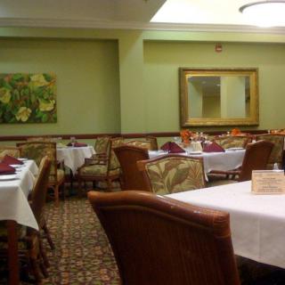 A cozy and elegantly decorated restaurant dining area with neatly arranged tables and chairs.