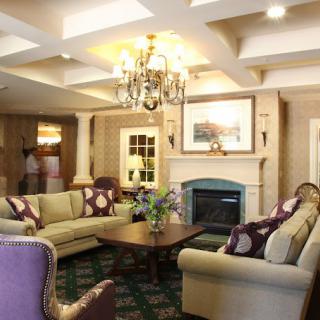 A cozy living room with elegant furnishings and a warm fireplace.