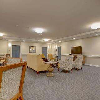 A spacious and well-lit living room with comfortable seating and a television.
