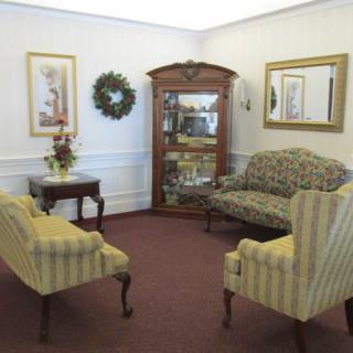A cozy living room with traditional furniture and decor.