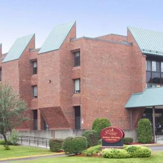 A brick building with modern architectural design and well-maintained landscaping.
