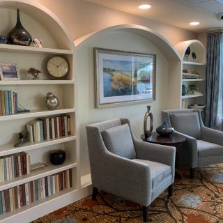 A cozy living room with elegant bookshelves and comfortable armchairs.