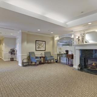 A cozy lobby with comfortable seating and a fireplace.