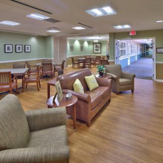 A comfortable lobby area with sofas and armchairs on a wooden floor.