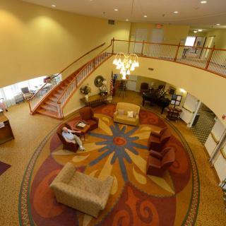 Cozy lobby area with comfortable seating and a grand staircase.