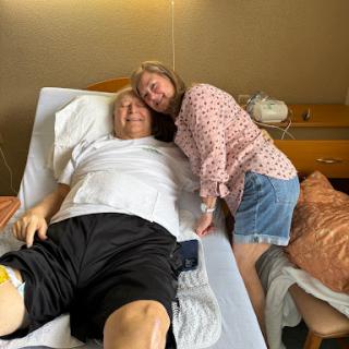 A moment of support and care in a hospital room.