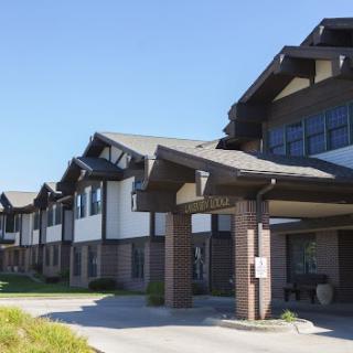 A modern residential building with a distinct architectural design under clear blue skies.
