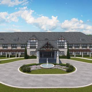 A large, elegant building with a central fountain and circular driveway.