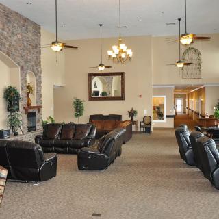 Spacious living room with leather seating and a fireplace.