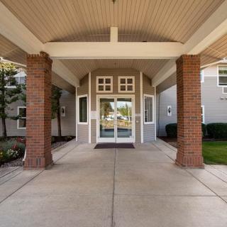 Front entrance of a building with brick columns and a pathway.