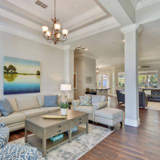 A spacious, modern living room with elegant decor and a cozy seating area.