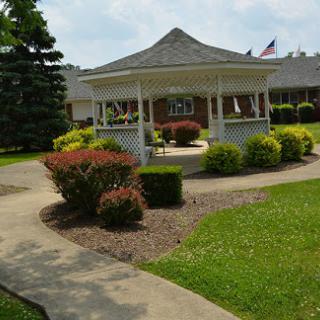 A peaceful garden area featuring a gazebo surrounded by well-maintained landscaping.