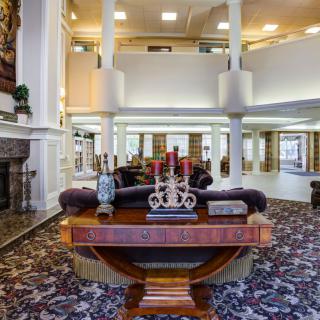 A spacious and elegantly decorated lobby with comfortable seating and ornate furnishings.