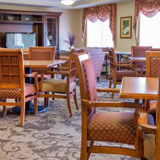 A well-furnished dining area with wooden chairs and tables.