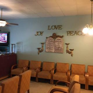 A cozy waiting room with arranged chairs and inspirational wall decorations.