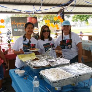 Community members enjoying a festive gathering with food and smiles.
