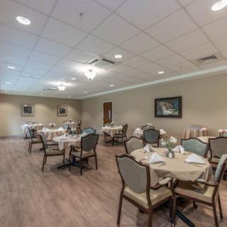 A spacious and elegantly decorated dining room with neatly arranged tables and chairs.