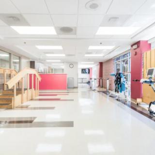A bright and spacious rehabilitation center with exercise equipment and therapy space.