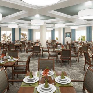 An elegantly designed dining room with neatly arranged tables and chairs, featuring sophisticated place settings and ambient lighting.