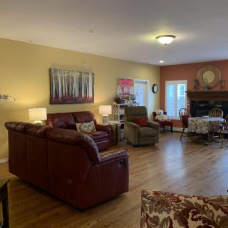 A cozy living room with comfortable seating, warm lighting, and a fireplace.
