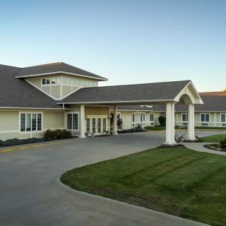 A well-maintained building with a covered entrance and manicured lawn.