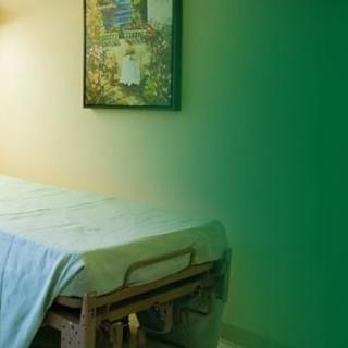 A calming spa treatment room featuring a massage table and soothing decor.