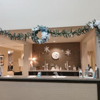 A beautifully decorated reception area featuring a holiday wreath and elegant decor.