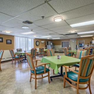 A spacious dining area designed for senior residents, featuring comfortable seating and a welcoming atmosphere.