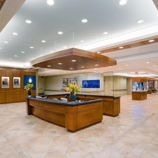 Modern office lobby with a reception desk and seating area.