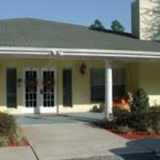 A single-story house with a covered entrance and landscaped front yard.