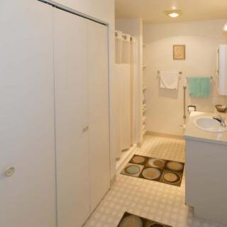 A modern bathroom featuring a sink, mirror, and neatly hung towels.