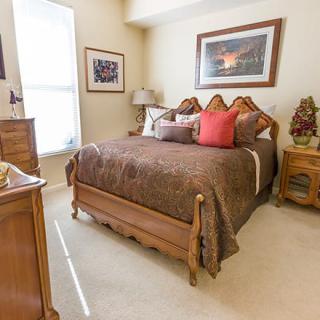 A cozy bedroom with elegant wooden furniture and decorative elements.