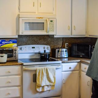 A cozy kitchen with various appliances on the countertop.