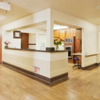 A modern reception area with wood flooring and a welcoming design.