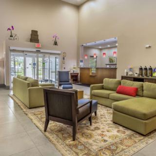 A welcoming lobby featuring comfortable green sofas and a stylish seating arrangement.