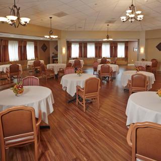 A spacious dining area with neatly arranged tables and chairs, designed for a comfortable dining experience.