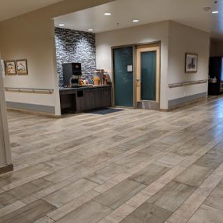 A spacious lobby area featuring modern decor and tiled flooring.