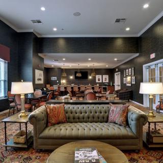 A cozy and elegantly designed living room with a comfortable sofa and warm lighting.