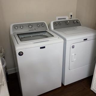 A laundry room with a washing machine and dryer set.