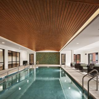 A luxurious indoor pool with modern design elements and a relaxation area.