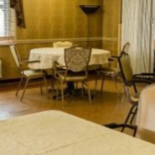 An indoor dining room with tables and chairs.