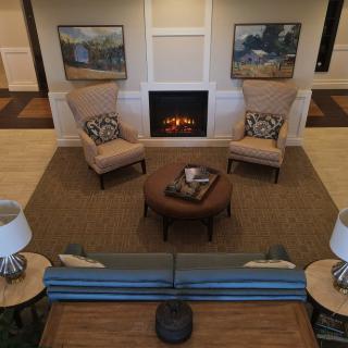 A cozy living room with a fireplace and comfortable seating arrangement.