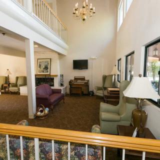Spacious living room with high ceilings and comfortable seating.