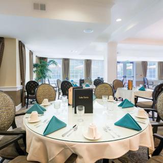 An elegantly set dining table in a well-lit restaurant interior.