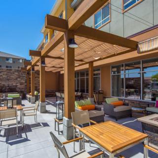 Outdoor patio area with wooden pergola and modern seating.