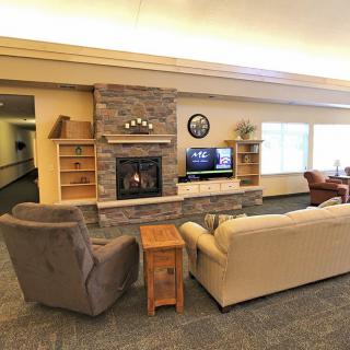 Cozy living room with a fireplace, television, and comfortable seating.