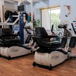A gym room featuring modern cardio exercise machines.