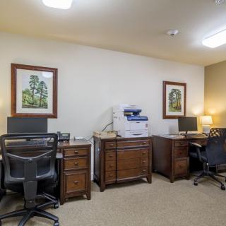 A well-organized office space with desks, computers, and a printer.