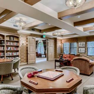 A cozy library with comfortable seating and ample bookshelves.